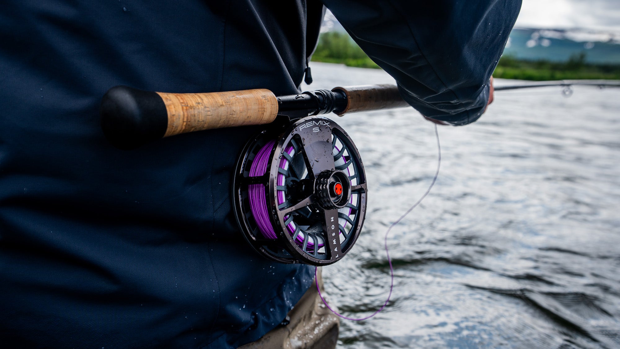 Lamson Remix S fly fishing reel in action with purple fly fishing line